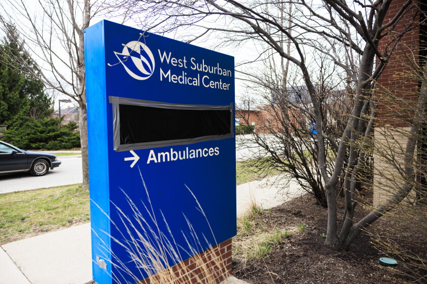 Black plastic covers the emergency room signs at West Suburban Medical Center in Oak Park showing that it is closed.