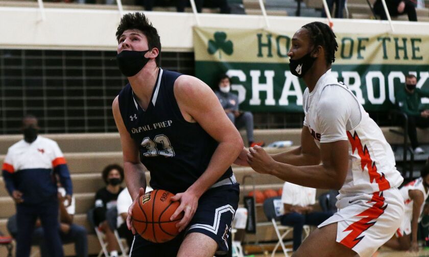 DePaul Prep’s Brian Mathews (33) moves to the basket as the Rams play Young.