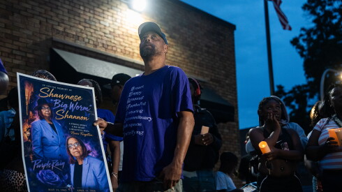 Shawnese Shannon’s brother Tim Shannon looks at balloons in the sky during a vigil outside South Chicago Chapel in South Deering.