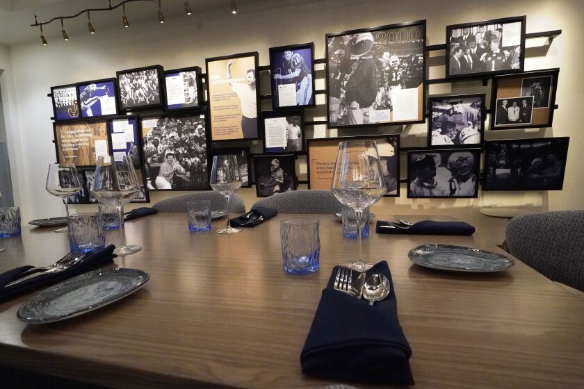 A table setting with photos and other memorabilia is viewed at Steve Spurrier’s Gridiron Grill