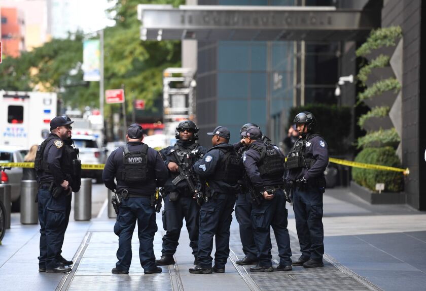 Police stand outside the Time Warner Building on Wednesday. A suspected explosive device was found in the building after it was delivered to CNN’s New York bureau. | Timothy A. Clary/AFP/Getty Images