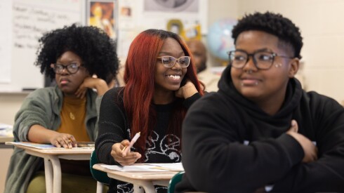 Students Damiyah Eberhart, Raqeebat Bankole and Ke’miah Richardson learn about the late Rev. Jesse Jackson in a social science class at King College Prep High School in Chicago's North Kenwood neighborhood earlier this month.
