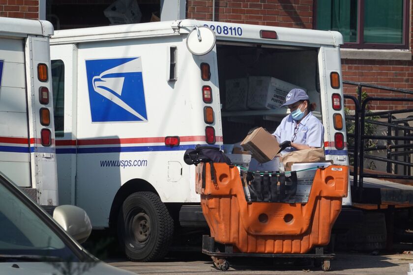 A postal worker loads a delivery truck on Oct. 1, 2021 in Chicago.