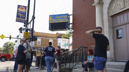 People stand outside Funston Elementary School, 3616 W. Armitage Ave., in Logan Square, on Oct. 3, there to support students and parents amid rumors of ICE officers appearing at the school at dismissal.