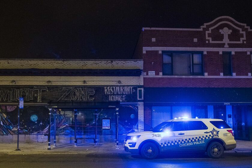 Chicago police investigate a person shot in the mouth and chest, Friday night, in the 3000 block of East 79th Street. | Tyler LaRiviere/Sun-Times