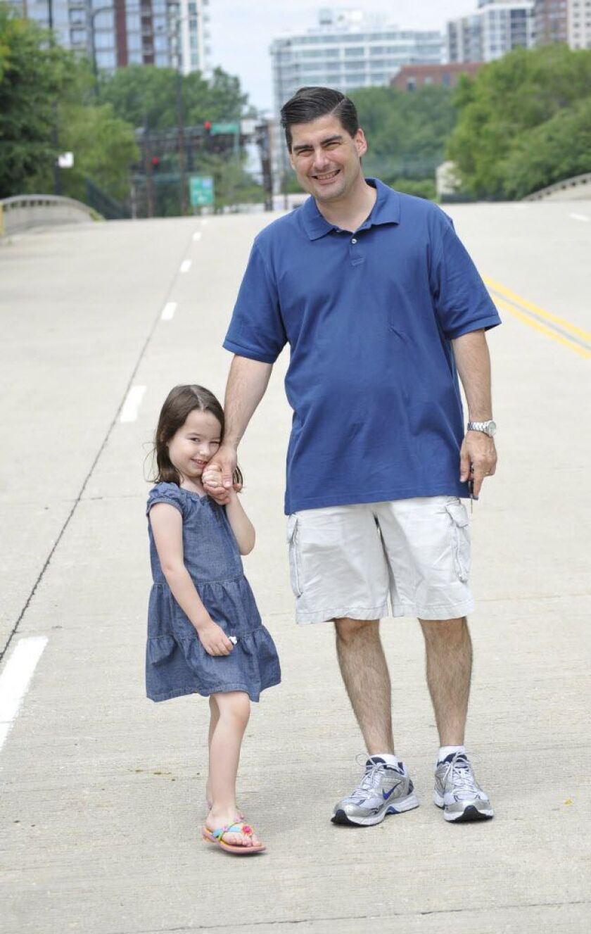 Grace Bauer, then 5, takes a moment for a photo with her dad, then-Lt. Paul Bauer of the Chicago Mounted Police Unit, as they leave a Father’s Day Mass at Gold Star Park in June 2010. | Sun-Times file photo