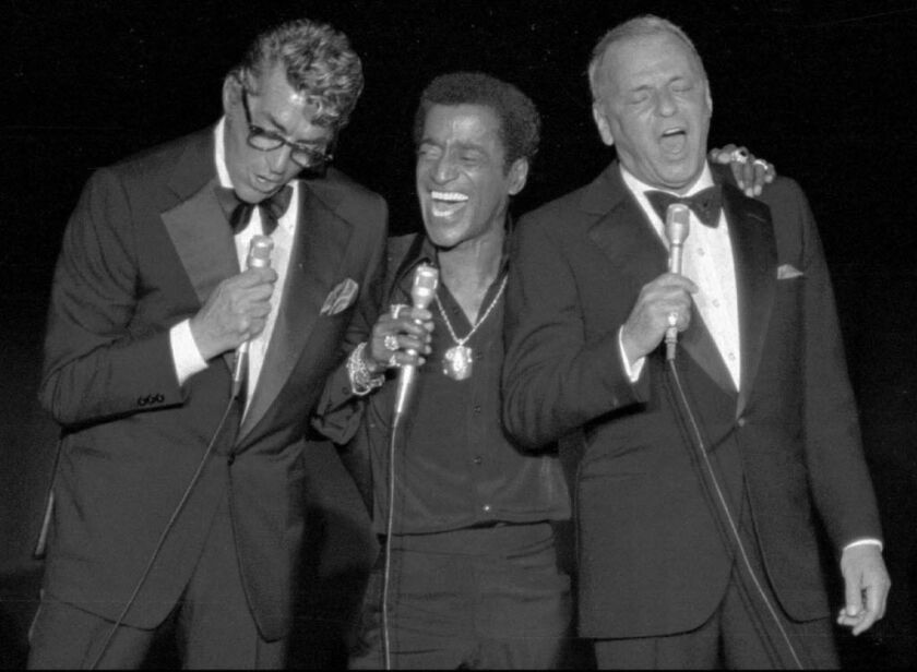 Frank Sinatra sings along with fellow Rat Pack members Dean Martin and Sammy Davis Jr., at a fund-raising reunion in Santa Monica, Calif., May 22, 1978, to benefit a charity. | AP Photo/File