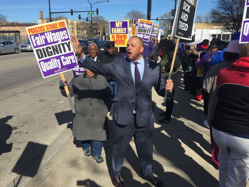 Kurt Summers pickets outside a nursing home at 69th and Wentworth with SEIU-Healthcare workers. Photo by Mark Brown