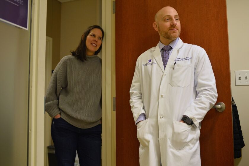 Dr. Ryan Merkow (right), a surgical oncologist at Northwestern Memorial Hospital, and Shannon Harrity, whose husband Sean O’Reilly is receiving chemotherapy with a specialized hepatic artery infusion pump at the Robert H. Lurie Comprehensive Cancer Center.
