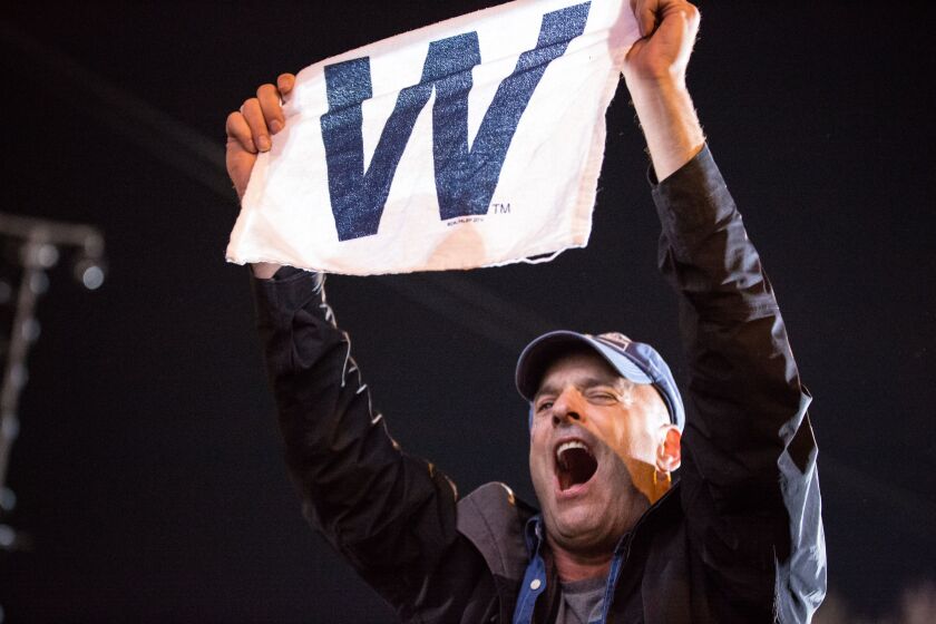 Fans celebrate the Cubs’ win outside Wrigley Field. | Santiago Covarrubias / Sun-Times