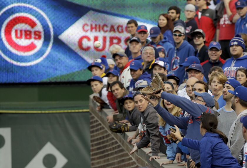 <em>Fans try to catch a fly ball during batting practice before Game 3 of the World Series at Wrigley Field. (AP)</em>