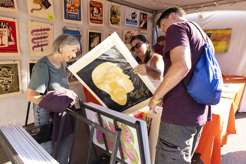 Festival-goers check out art by local artists on day one of the Pitchfork Music Festival, Friday, Sept. 10, 2021.