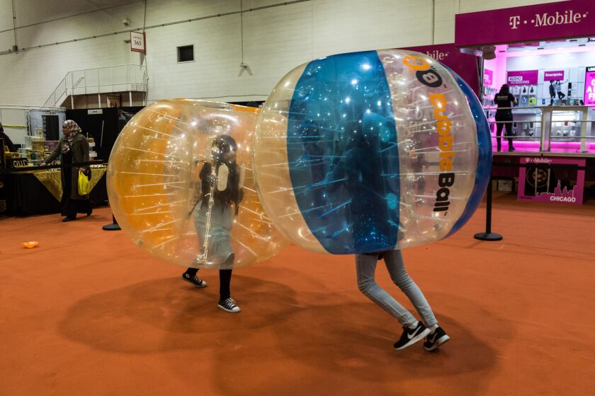 Fariha Siyadath (left) and Zainab Ibrahim, both 13, play at the I Heart Halal Festival at Navy Pier on Friday. | Erin Brown/Sun-Times