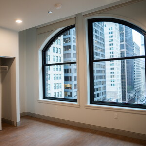Inside the bedroom of a two-bedroom unit, with views of Downtown out a large window, at the Bellwether Residences in the Loop.