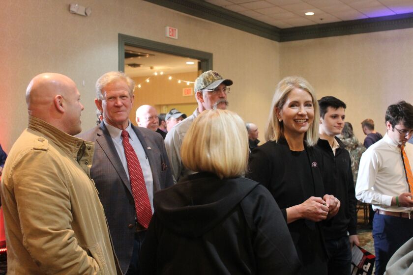 State Rep. Chris Miller, second from left, and his wife, U.S. Rep. Mary Miller; in black, facing camera; at state Sen. Darren Bailey’s gubernatorial campaign kick-off in Effingham on Monday.