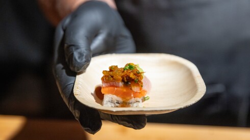 Chef Jeffrey Steelman of Wicker Park Seafood and Sushi in Chicago servers Ora King Salmon and Hamachi with watermelon, yuzu and Chili Crisp at the post-ceremony reception at Union Station Monday night after the James Beard Awards at the Lyric Opera House in Chicago on June 16, 2025.