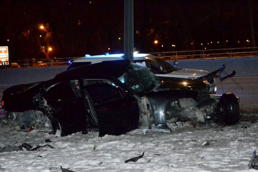 A Dodge Charger slammed into a pole Tuesday night on Lake Shore Drive near Hyde Park, leaving the driver and two passengers injured. | Justin Jackson/Chicago Sun-Times