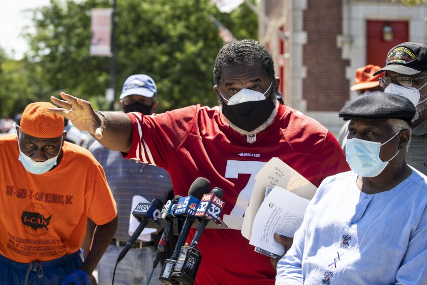 Flanked by supporters, Ezra McCann, 70, a retired firefighter of 30 years at the Chicago Fire Department, decries alleged racism in the department during a press conference outside Station 45, 4600 S. Cottage Grove Ave.