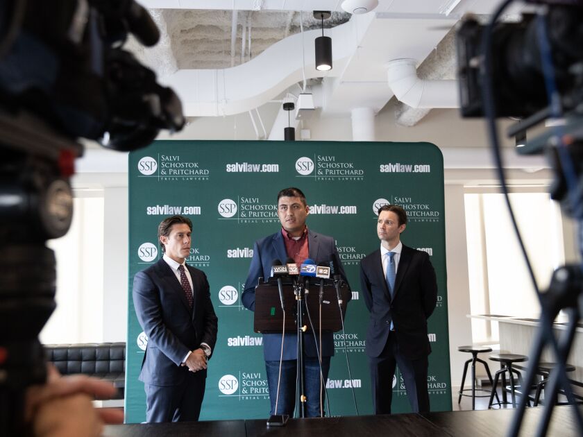 From left: Attorney Parker Stinar of the Stinar Law Firm, former Northwestern football player Ramon Diaz and Patrick Salvi II of Salvi, Schostok and Pritchard speak to the media a press conference on Wednesday, Aug. 2, 2023 at the Salvi, Schostok and Pritchard law office in Chicago.
