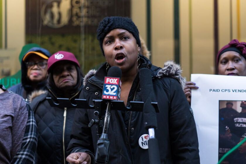 Anika Mathews, a parent of a National Teachers Academy student, speaks at a news conference outside CPS headquarters in support of keeping NTA open. | Max Herman / Sun-Times