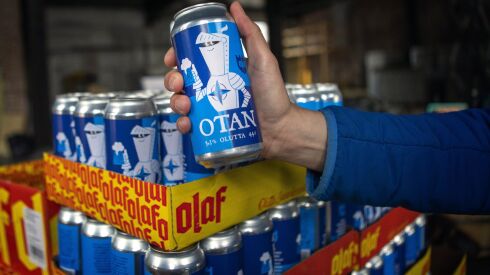 Beer cans with writing OTAN inspired by the North Atlantic Treaty Organization (NATO) logo by Olaf Brewing Company are displayed in Savonlinna, eastern Finland, Tuesday, May 17, 2022. 