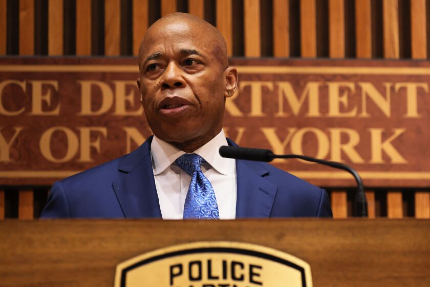 New York Mayor Eric Adams announcing charges against five people accused of drugging bar patrons to rob them. John Umberger, a political consultant whose bank account was drained using apps on his phone, was one of two victims who died.