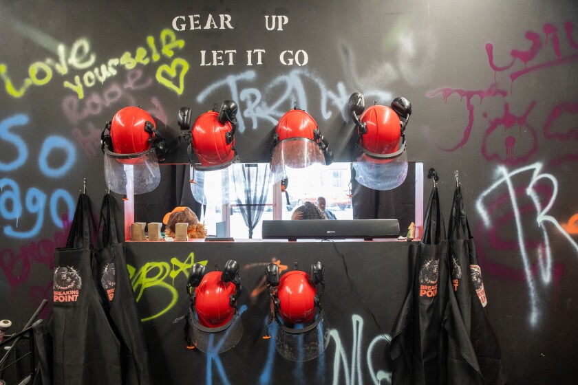 Safety equipment hangs on the walls the orientation room at Breaking Point Rage Room