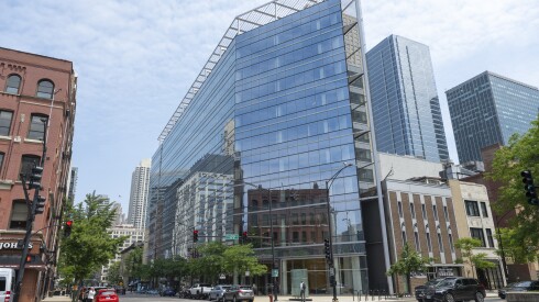 Street view of the glass office tower that will become apartments at 111 W. Illinois St. in River North.