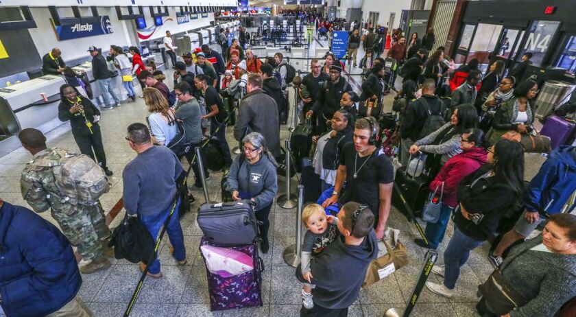 The ticket counters are swamped with travelers on Monday Dec. 18, 2017, at Hartsfield-Jackson International Airport in Atlanta. |<br>John Spink/Atlanta Journal-Constitution via AP