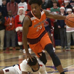 Bro. Rice’s Marquise Kennedy (24) pushes off St. Rita’s Joel Watts (3) Tuesday 12-04-18 Robinson/For Sun-Times
