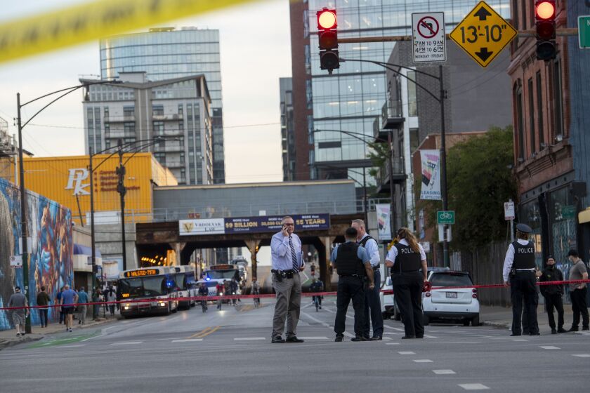 Chicago police work the scene where multiple people were shot near the Grand Avenue, Halsted Street, and Milwaukee Avenue intersection, in the West Town neighborhood, Wednesday, Sept. 29, 2021.