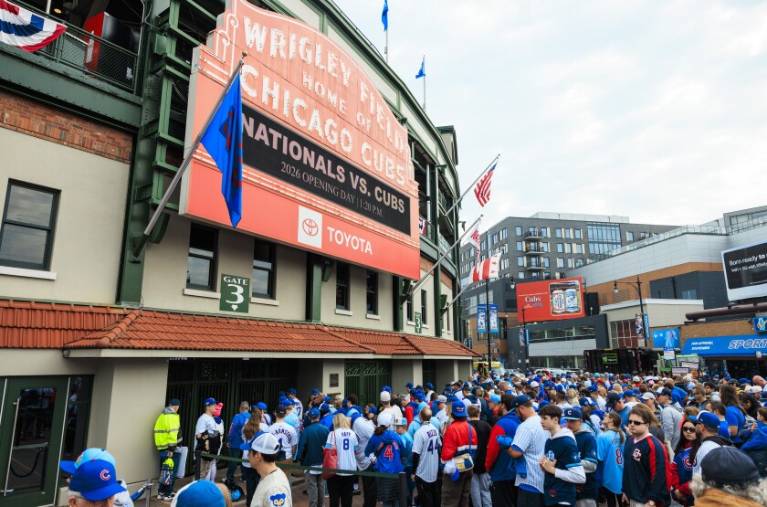 Fans wait in line Thursday to enter Wrigley Field on the Chicago Cub’s opening day.
