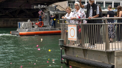 Flower petals are tossed into the Chicago River during a ceremony commemorating the victims of the S.S. Eastland disaster. The 111th anniversary of the tragedy war marked on Friday, July 24, 2026 with a ceremony along the Chicago Riverwalk near the Clark Street Bridge. More than 800 perished with the Eastland rolled onto its side in the river.