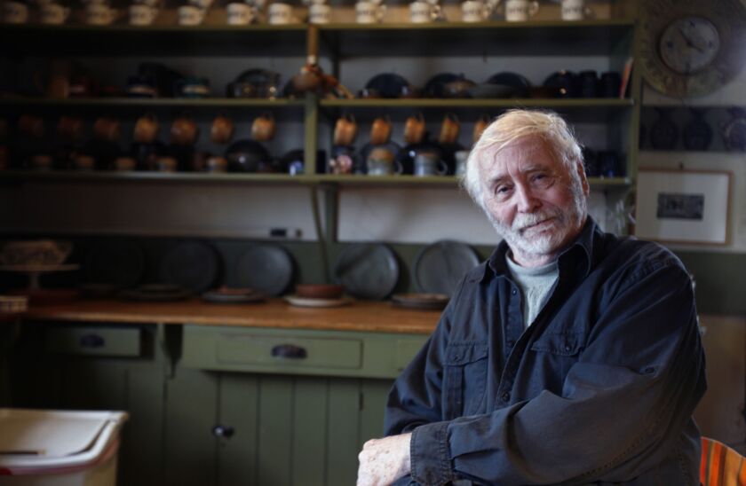 In this May 14, 2009 file photo, pop artist Robert Indiana, 80, poses in the kitchen at his home on Vinalhaven Island, Maine. Indiana, best known for his 1960s LOVE series, died from respiratory failure Saturday, May 19, 2018, at his home in Maine, Indian