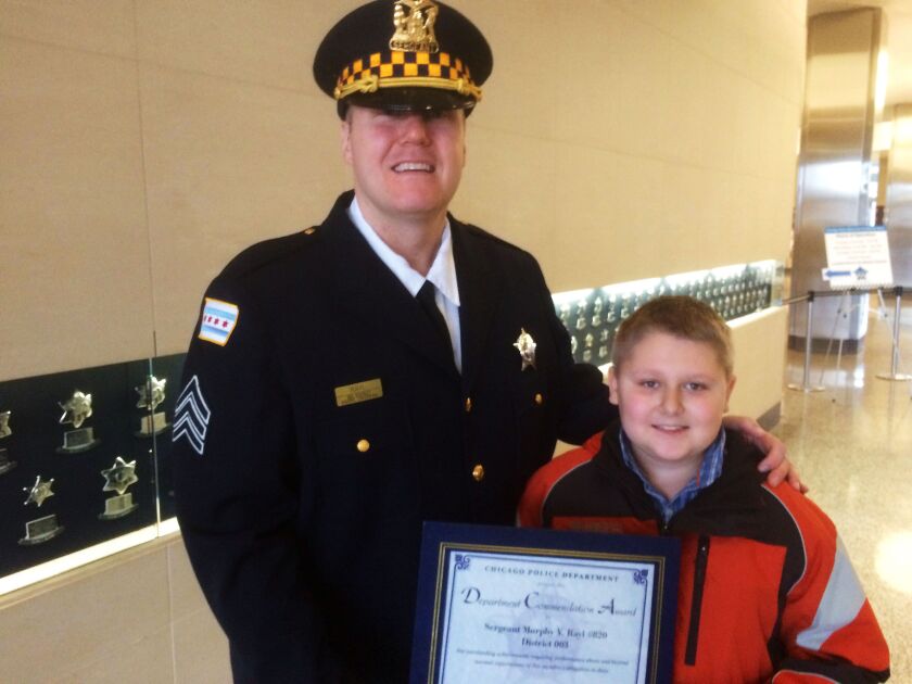 <small><strong> Sgt.Murphy Rayl with son Brendan. Mitch Dudek/Sun-Times</strong></small>