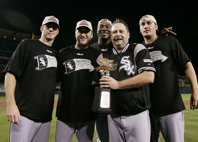 <em>White Sox pitchers, from left, Jon Garland, Mark Buehrle, Jose Contreras, and Freddy Garcia, far right, with pitching coach Don Cooper, second right, holding the American League Champiosnhip trophy after they beat the Los Angeles Angels in Game 5 of t