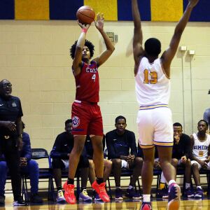 Curie’s Saiveon Williams (4) shoots from beyond the arc as Simeon’s Phillips Holmes, Jr., defends.