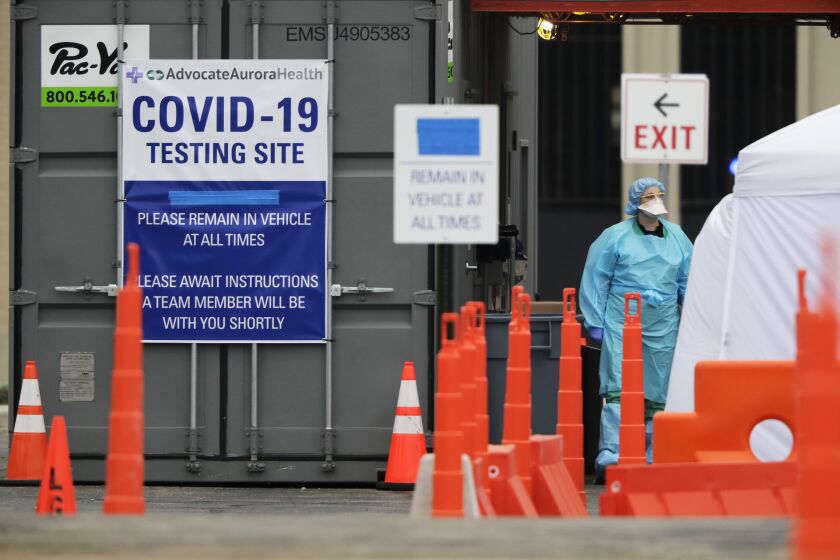 Medical personnel at Advocate Lutheran General Hospital, conduct drive-thru COVID-19 testing in Park Ridge.