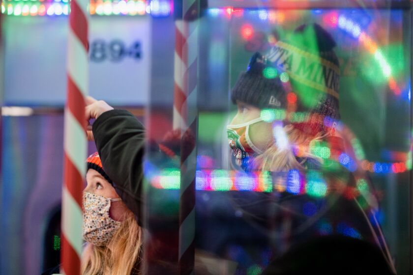 Kooper Andringa and Tara Gutzman ride the CTA Holiday Train around the Loop on Monday afternoon, Dec. 20, 2021.