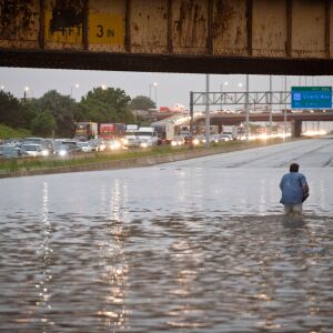 6-23-10 All traffic on the Stevenson Expressway stopped due to flooding just east of Pulaski. A man took off his shoes and just walked through the water.