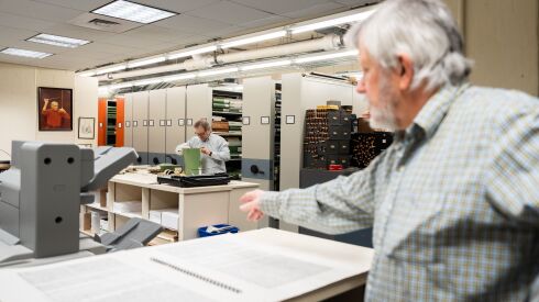 Chicago Symphony Orchestra’s librarian Mark Swanson (front) views an oversized score in the Symphony Center library.