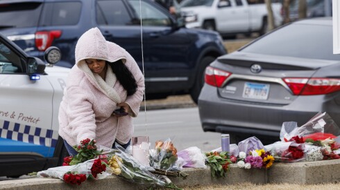 A mourner places flowers at a memorial for Rev. Jesse Jackson outside of Rainbow PUSH Coalition Headquarters in Kenwood, Tuesday, Feb. 17, 2026. Rev. Jackson passed away at the age of 84.