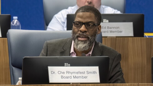 Chicago Board of Education member Che Rhymefest Smith, seen at a Board of Education meeting in 2025, has raised $100,000 for reelection, though he faces no opponent on the ballot.