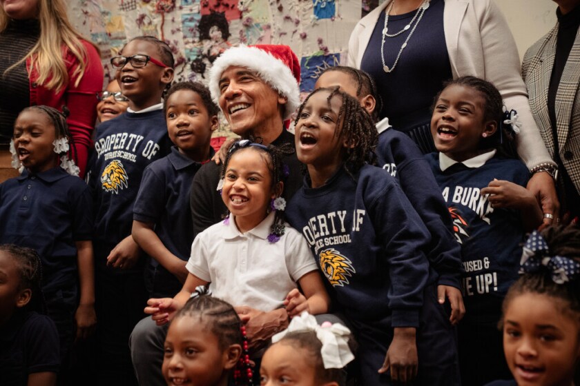 Former President Barack Obama poses with kids from Burke Elementary at the Bessie Coleman Chicago Public Library branch in Woodlawn on Tuesday.