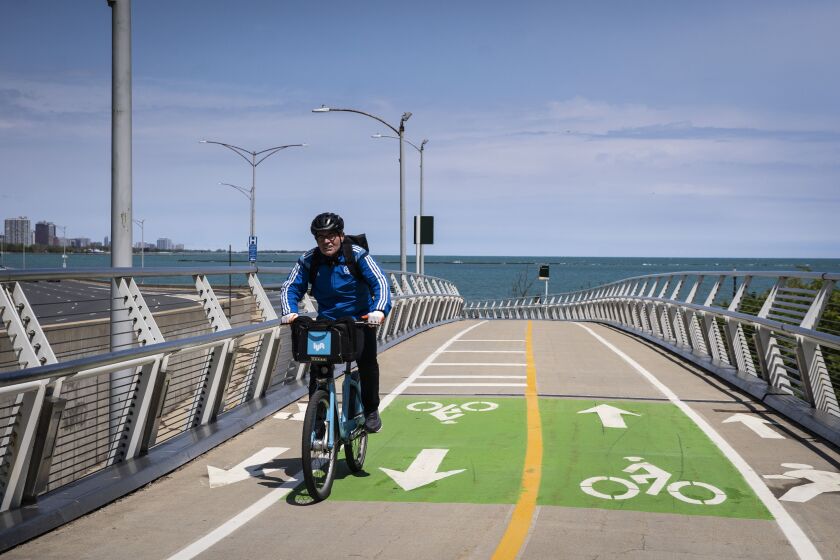 A bicyclist rides on the Navy Pier Flyover on the newly-completed part of the path that tracks the Lake Shore Drive Bridge over the mouth of the Chicago River, Monday morning, May 10, 2020.