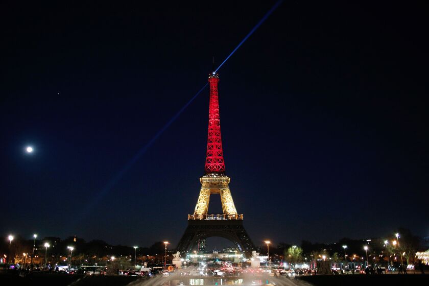 The Eiffel Tower is illuminated with the Belgium national colors black, yellow and red in honor of the victims of the today’s attacks at the airport and the metro station in Brussels. | Thibault Camus/Associated Press