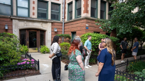 Potential homebuyers and their agents wait outside of an open house in June for a one-bedroom condo in Lake View.