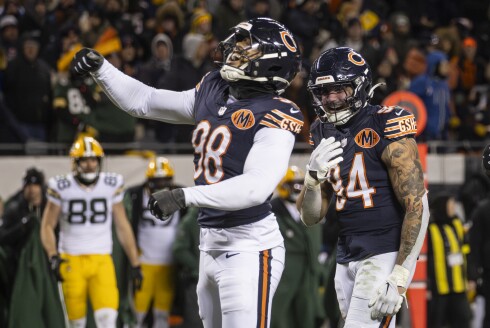Bears defensive end Montez Sweat, left, celebrates after sacking Green Bay Packers quarterback Malik Willis to force overtime at Soldier Field on Saturday, Dec. 20, 2025.