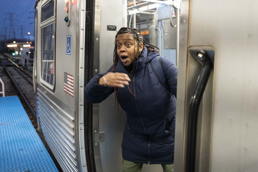 Shanesha McCray gestures for her friend to board a southbound Yellow Line train at the Dempster station in Skokie, Ill., Friday, Jan. 5, 2024. Yellow Line trains to and from Skokie, Ill. resumed Friday after they were suspended following a train crash on November 16. McCray and her friend were excited to ride the train to work. Riding the bus while the Yellow Line was suspended added about 30-35 minutes one way to their commute, they said. | Pat Nabong/Sun-Times
