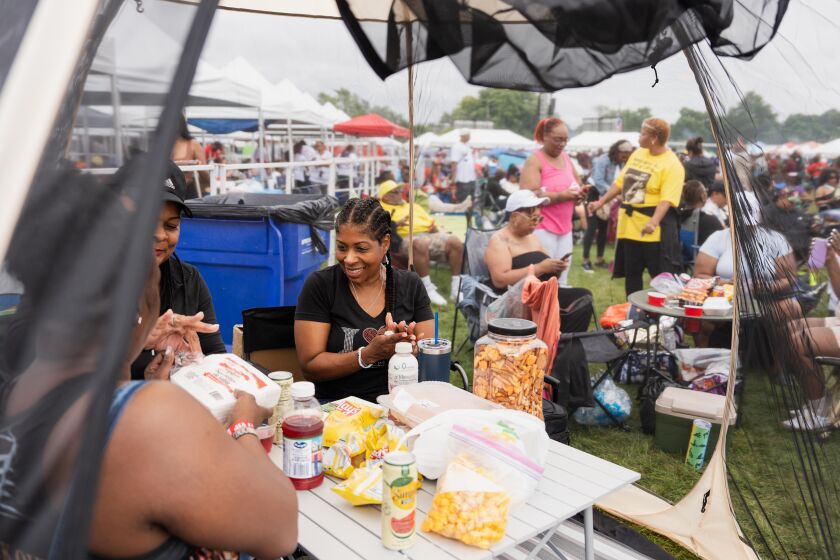 People prepare to eat inside a tent during the Chosen Few Picnic at Jackson Park in the Woodlawn neighborhood, Saturday, July 8, 2023. | Pat Nabong/Sun-Times